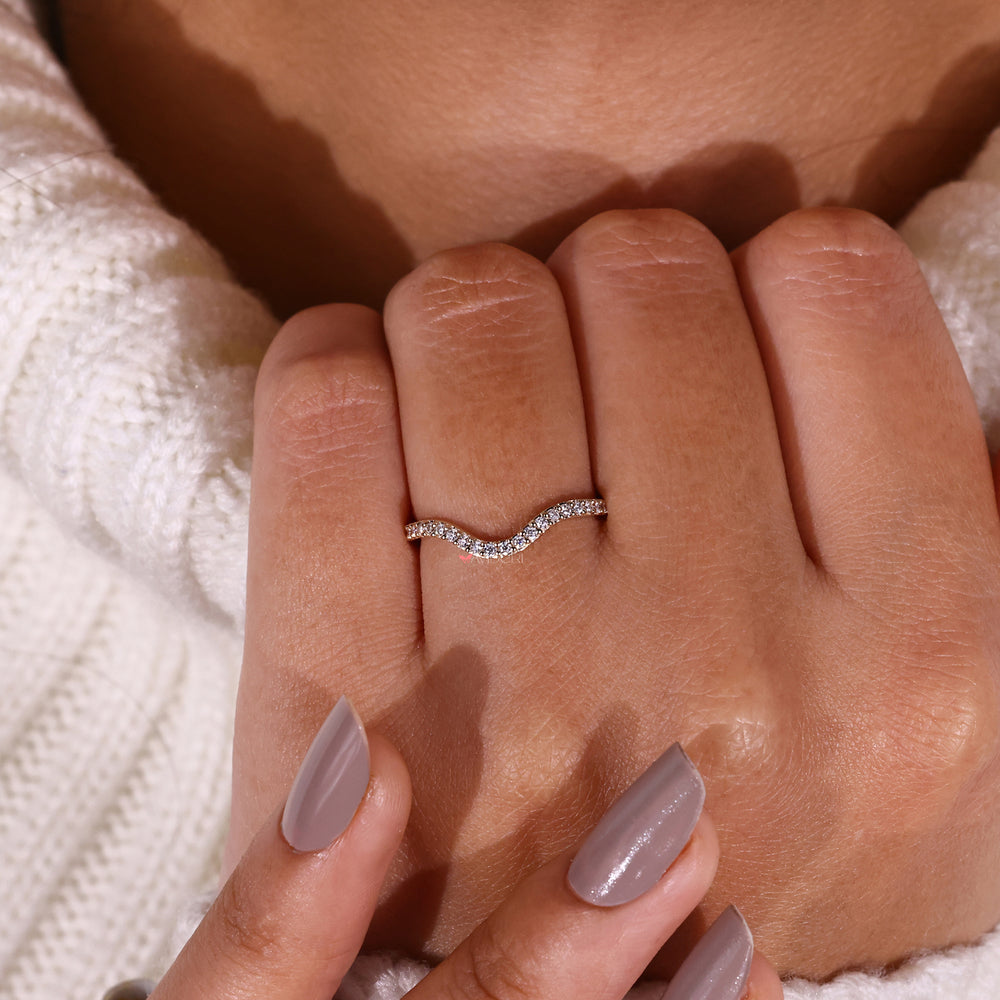 Stunning curved gold wedding band with round cut diamond wedding band for added brilliance.