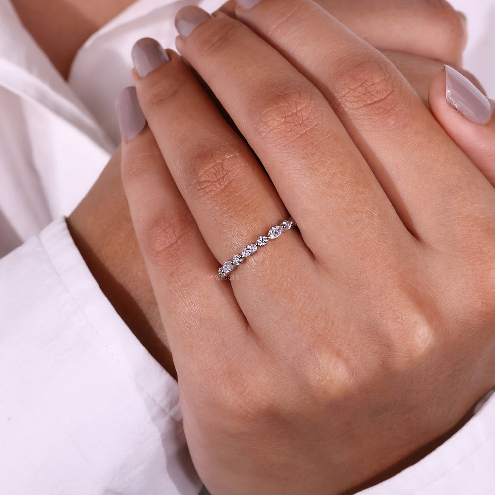 Sophisticated white gold wedding band featuring a shared prong setting for a secure fit.
