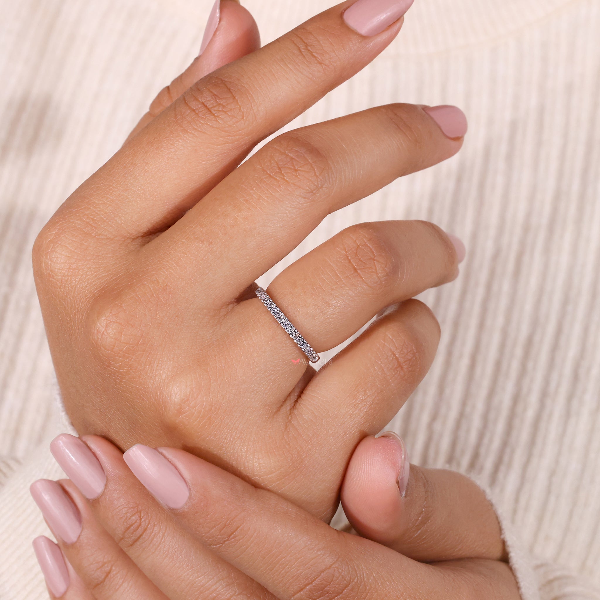 Delicate handmade jewelry featuring a round diamond half eternity band.
