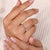 Delicate handmade jewelry featuring a round diamond half eternity band.
