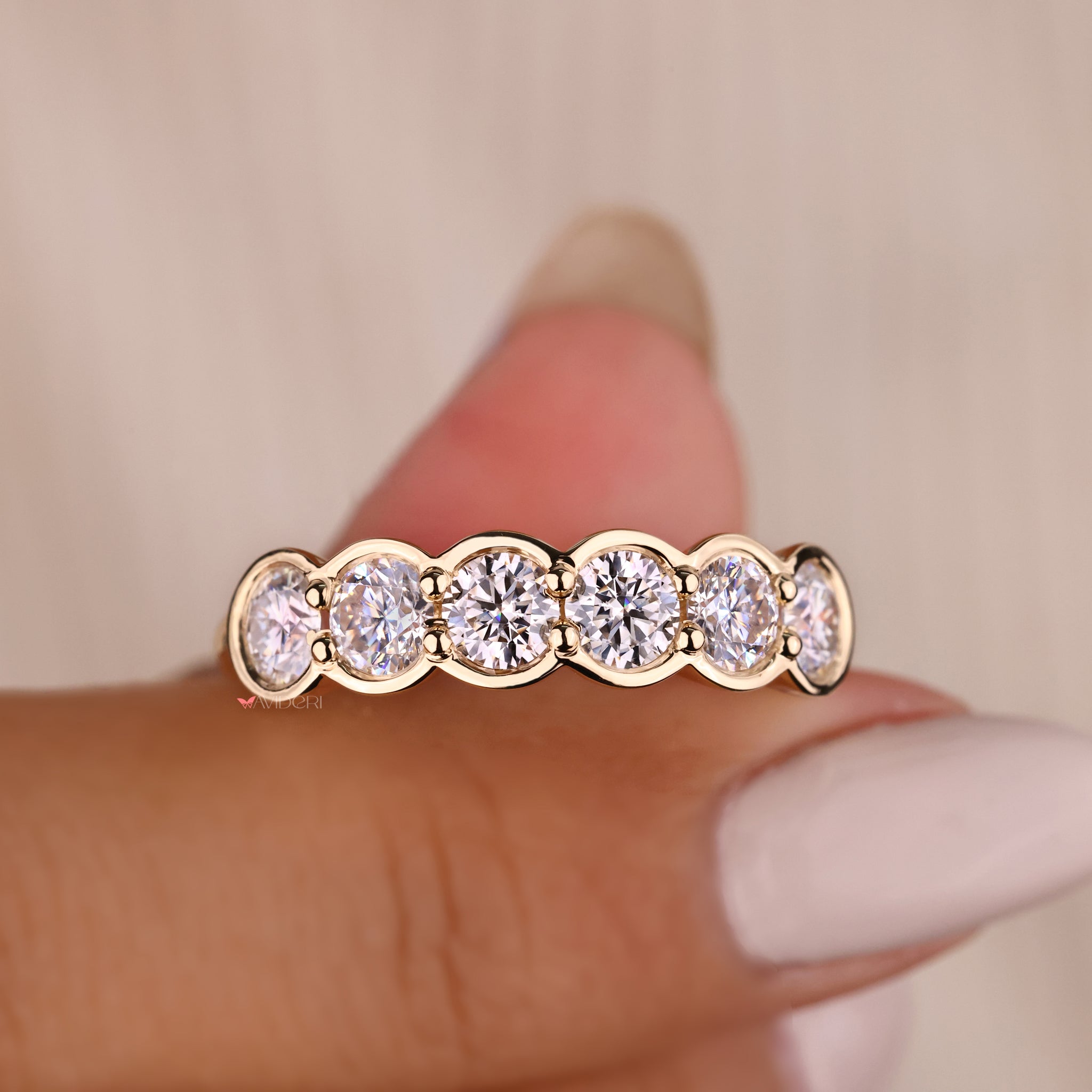 Classic yellow gold wedding band with six diamonds.
