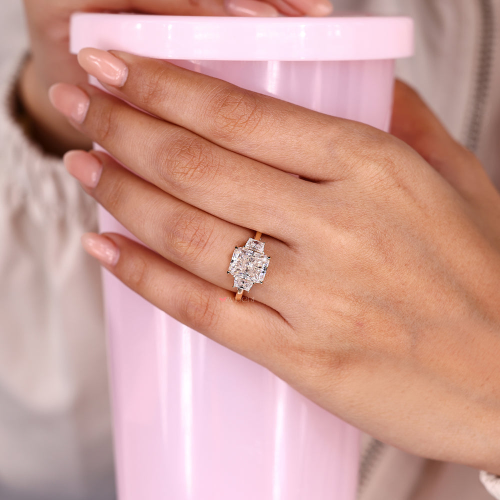 Three stone radiant cut moissanite engagement ring.
