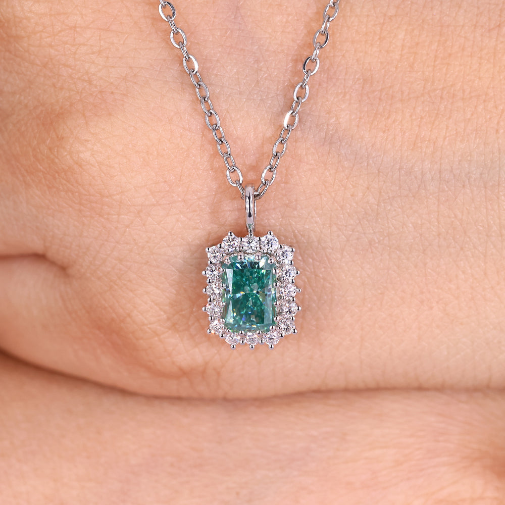 Radiant cut cyan blue moissanite halo pendant.
