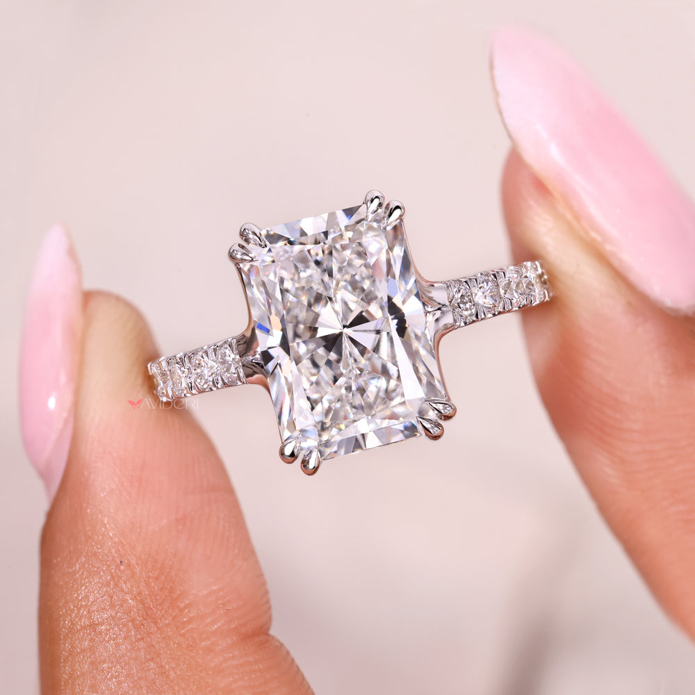 Radiant cut diamond ring with modern double claw prongs.

