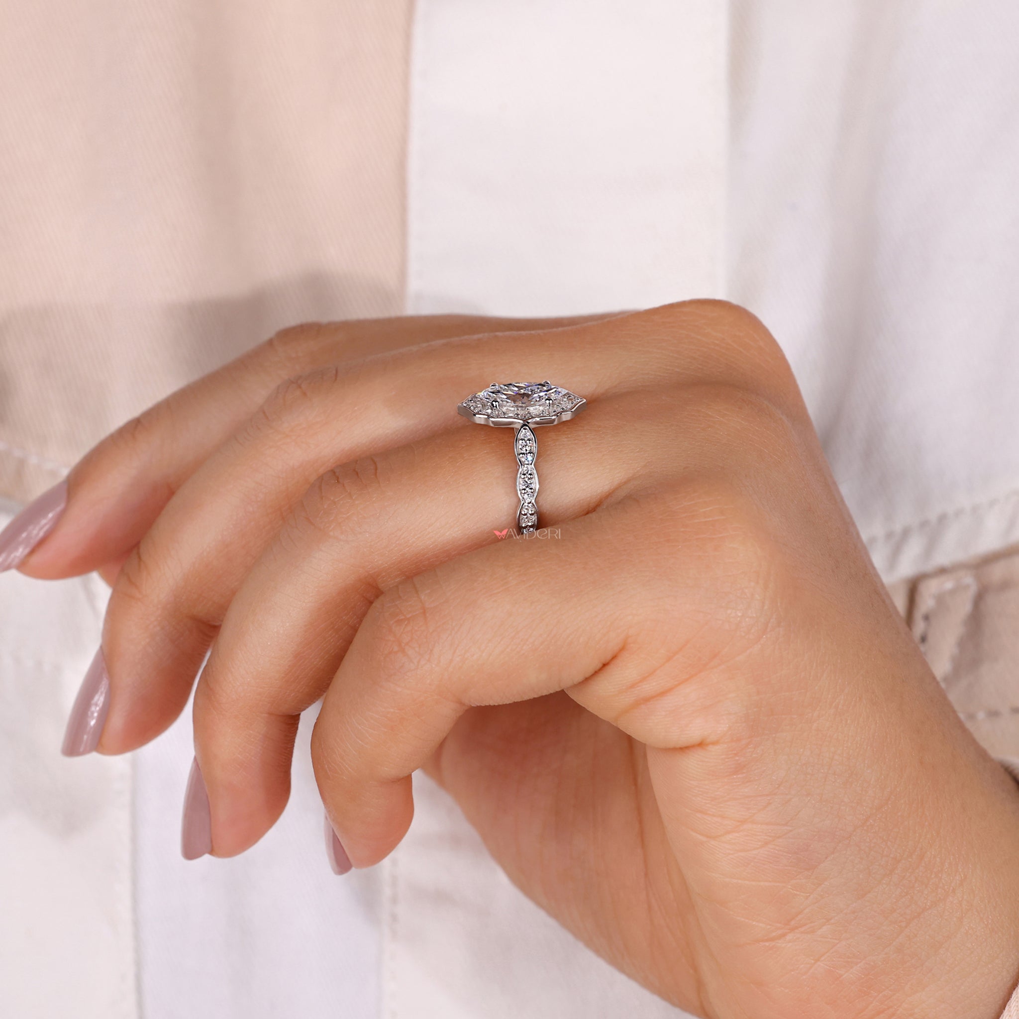 Halo ring featuring a marquise shaped ring design.
