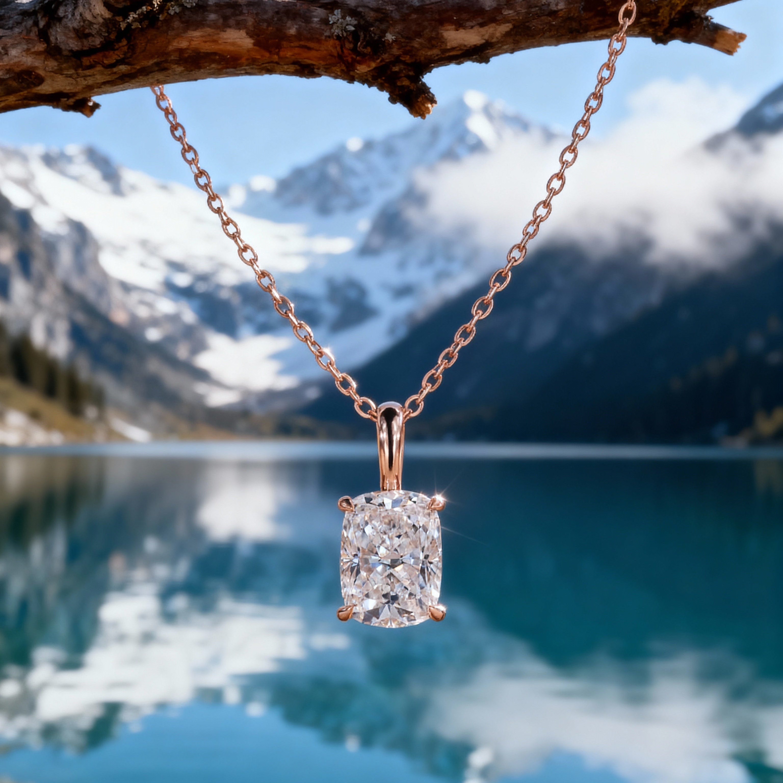 Diamond necklace hanging from a branch over a mountain lake