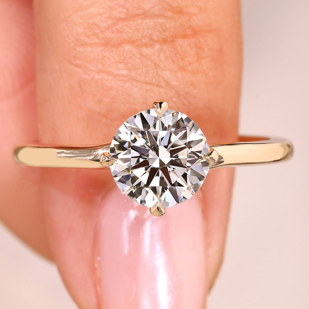 Round cut lab grown diamond ring with bypass setting.
