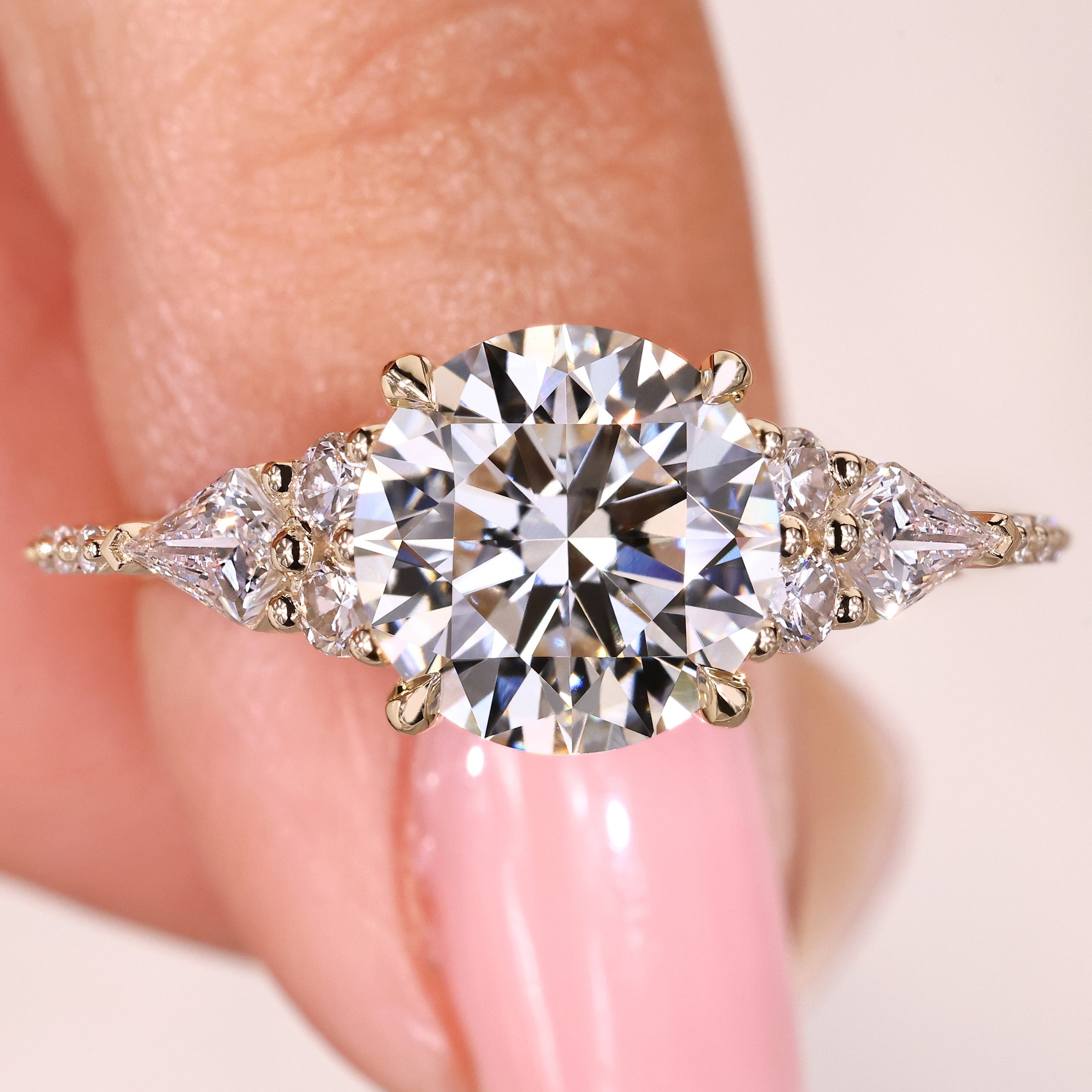 Round cut diamond ring with kite and round side stones
