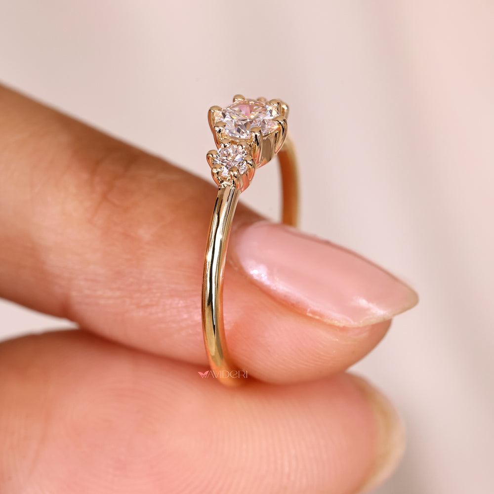 Round diamond ring with three stone design.
