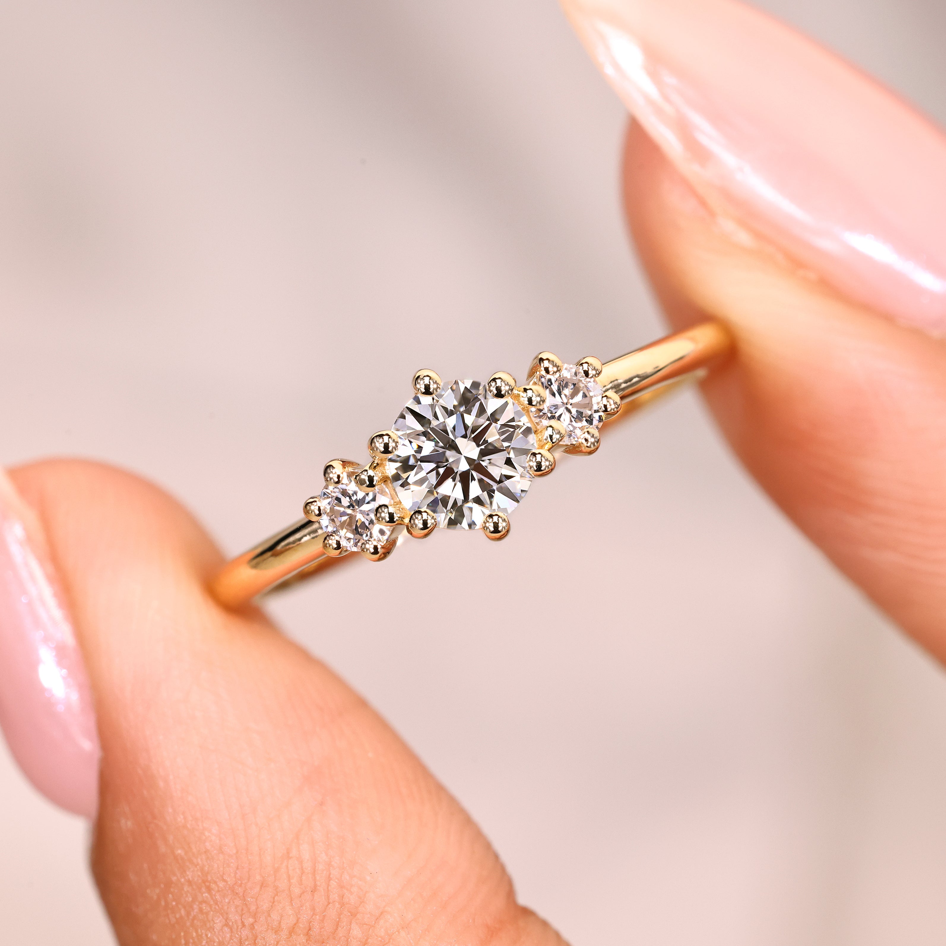 Round cut ring with prong set three stones.
