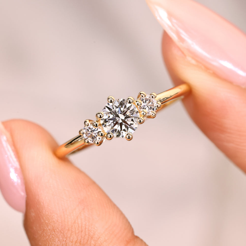 Round cut ring with prong set three stones.
