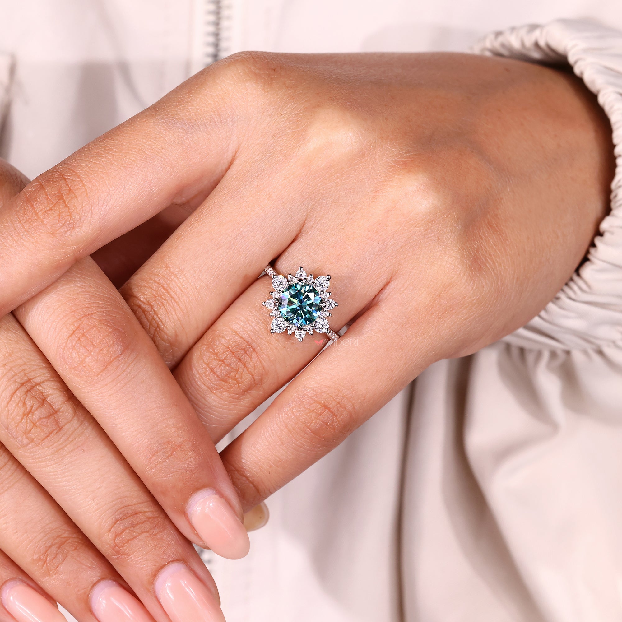 Cyan blue moissanite ring with sparkling cluster.
