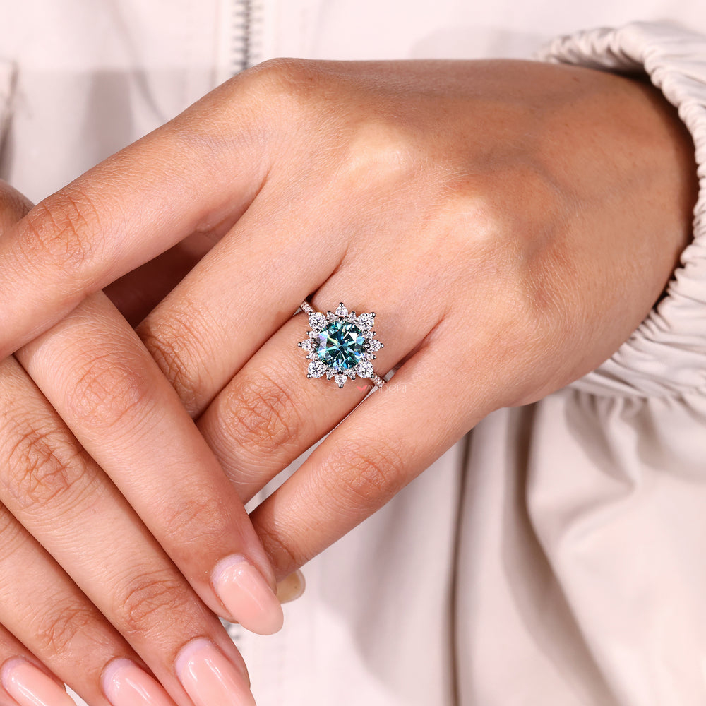 Cyan blue moissanite ring with sparkling cluster.
