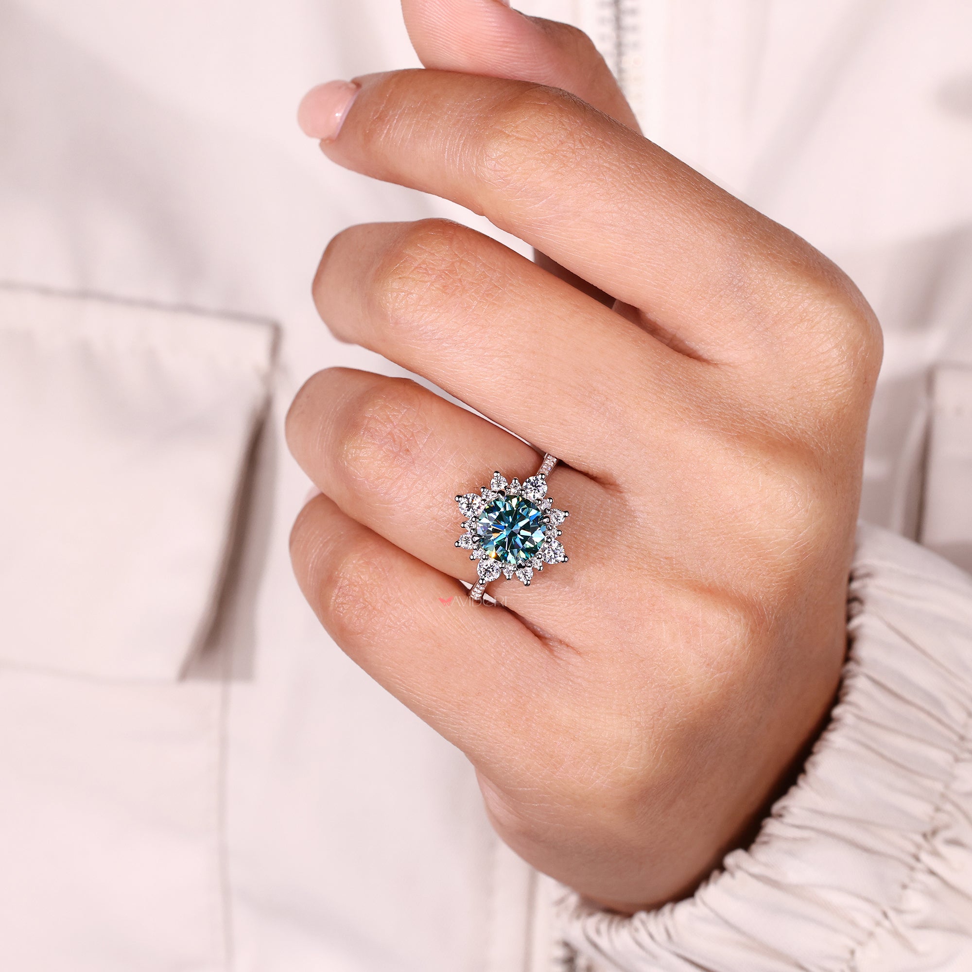 Cyan blue moissanite ring with round accents.
