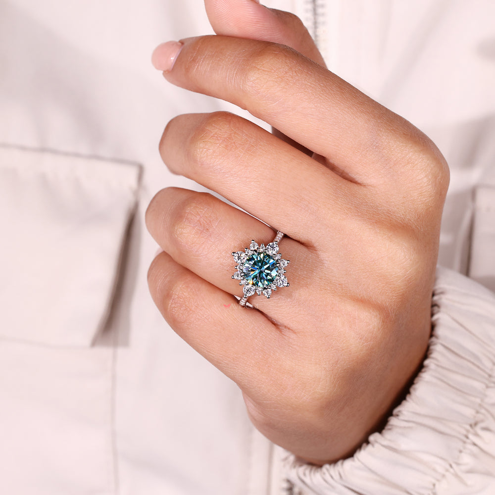 Cyan blue moissanite ring with round accents.
