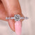 Round diamond engagement ring with marquise side stones.
