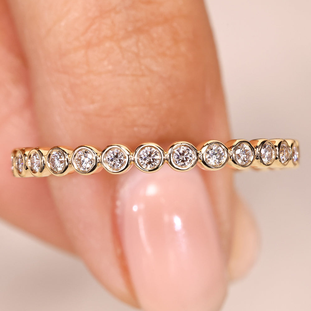 Round diamond wedding band eternity bezel style.
