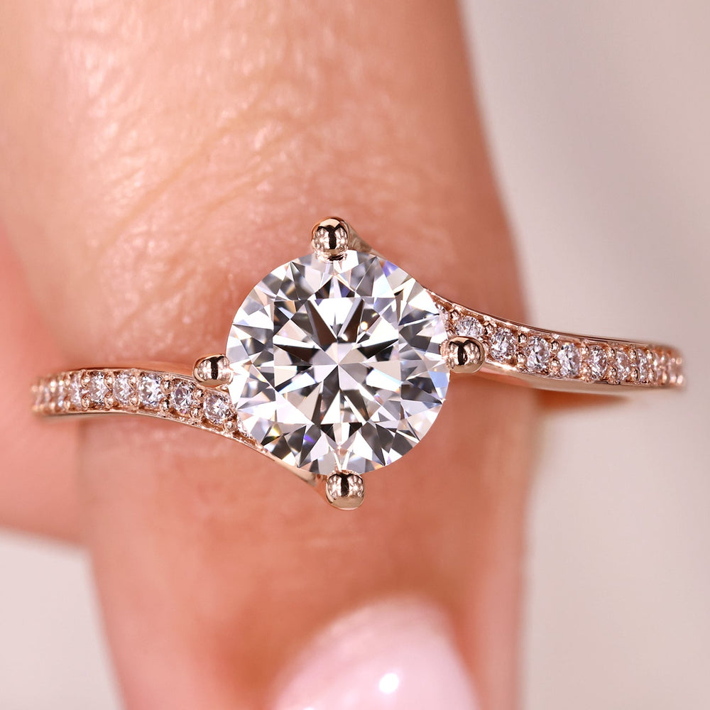 Round diamond engagement ring with pave style band.
