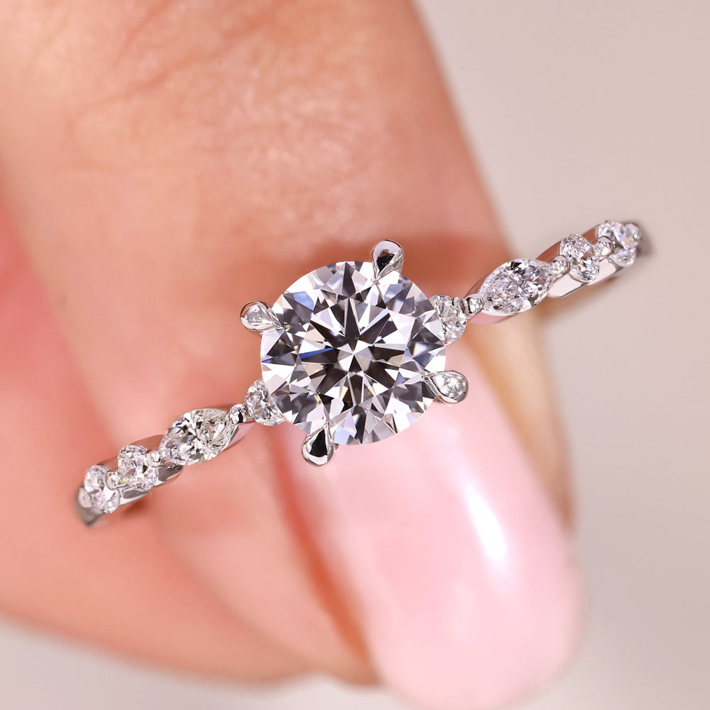 Round cut diamond ring in polished white gold.