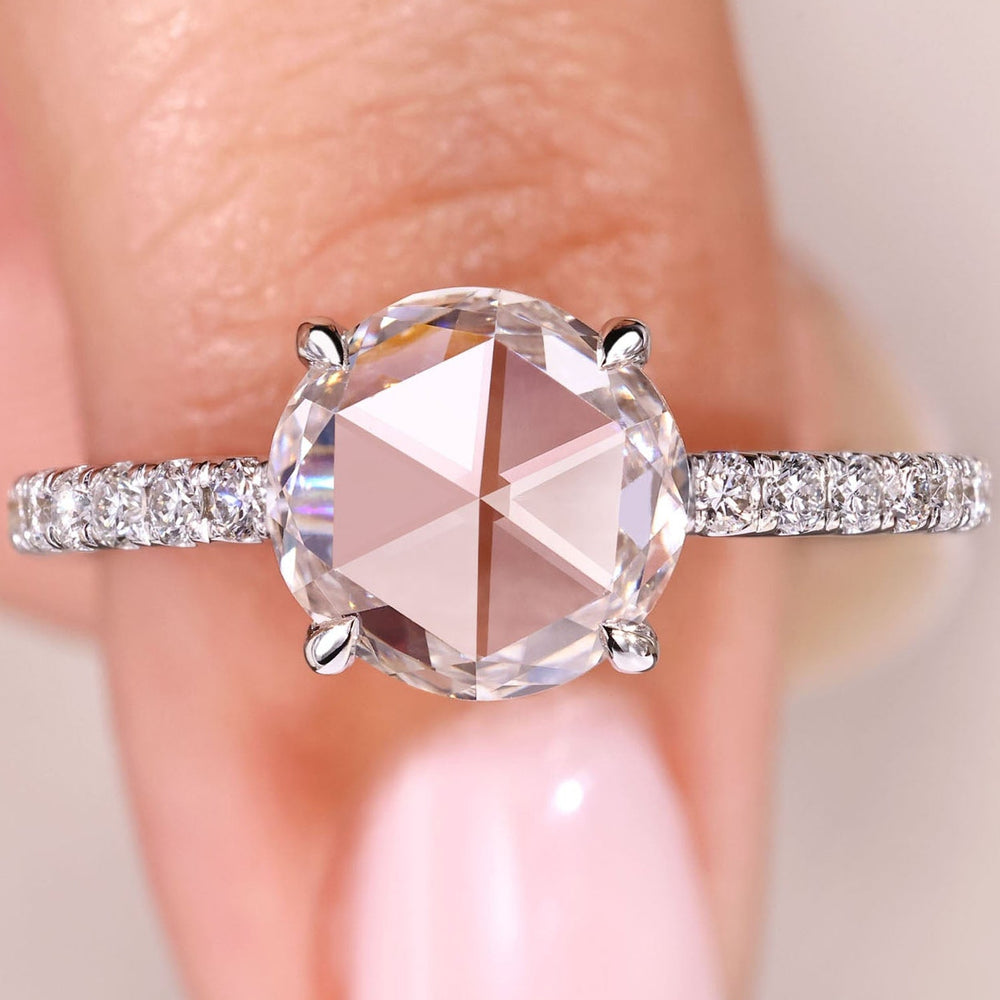 Round rose cut diamond ring with pave style band.