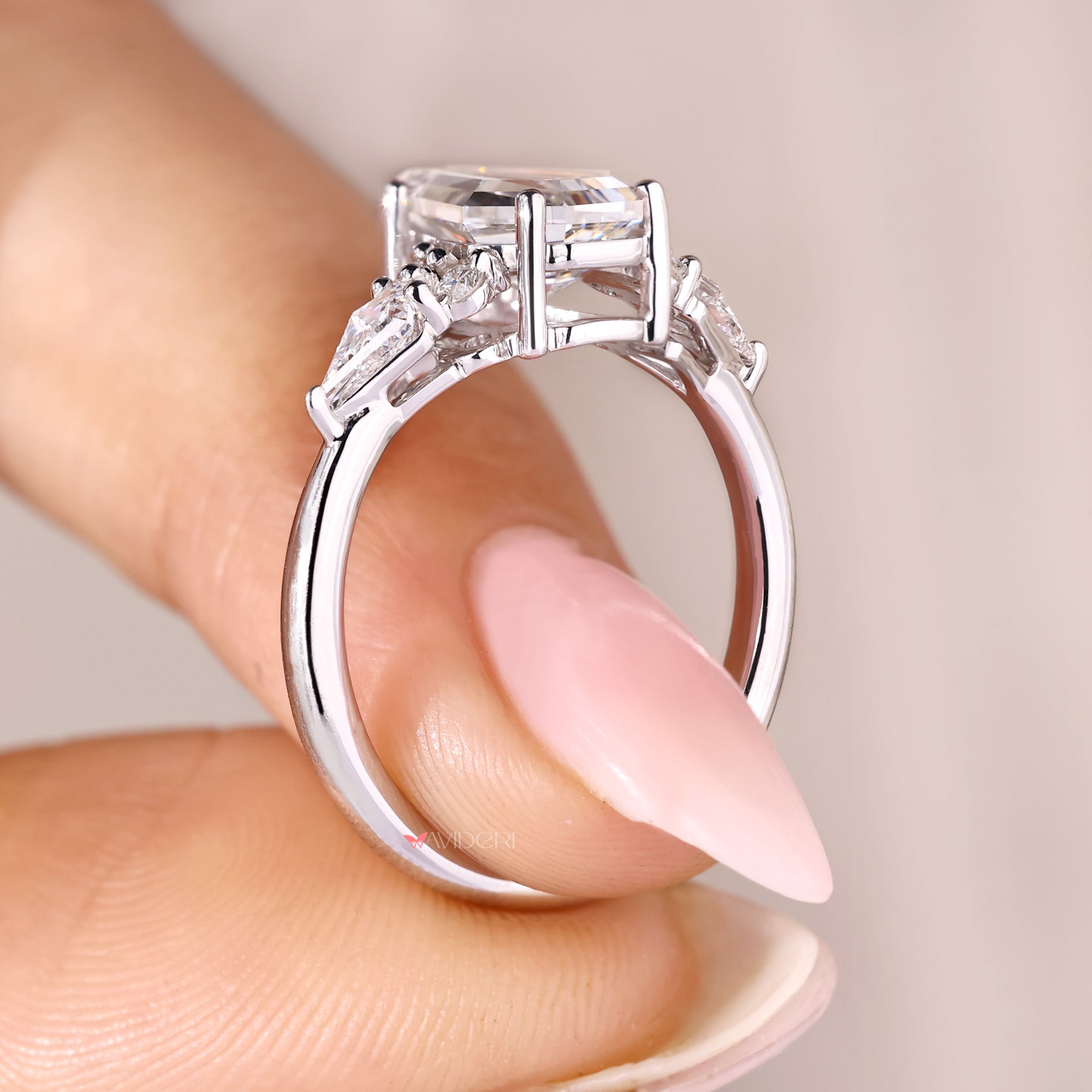 White gold coffin cut diamond ring with tapered shank band.