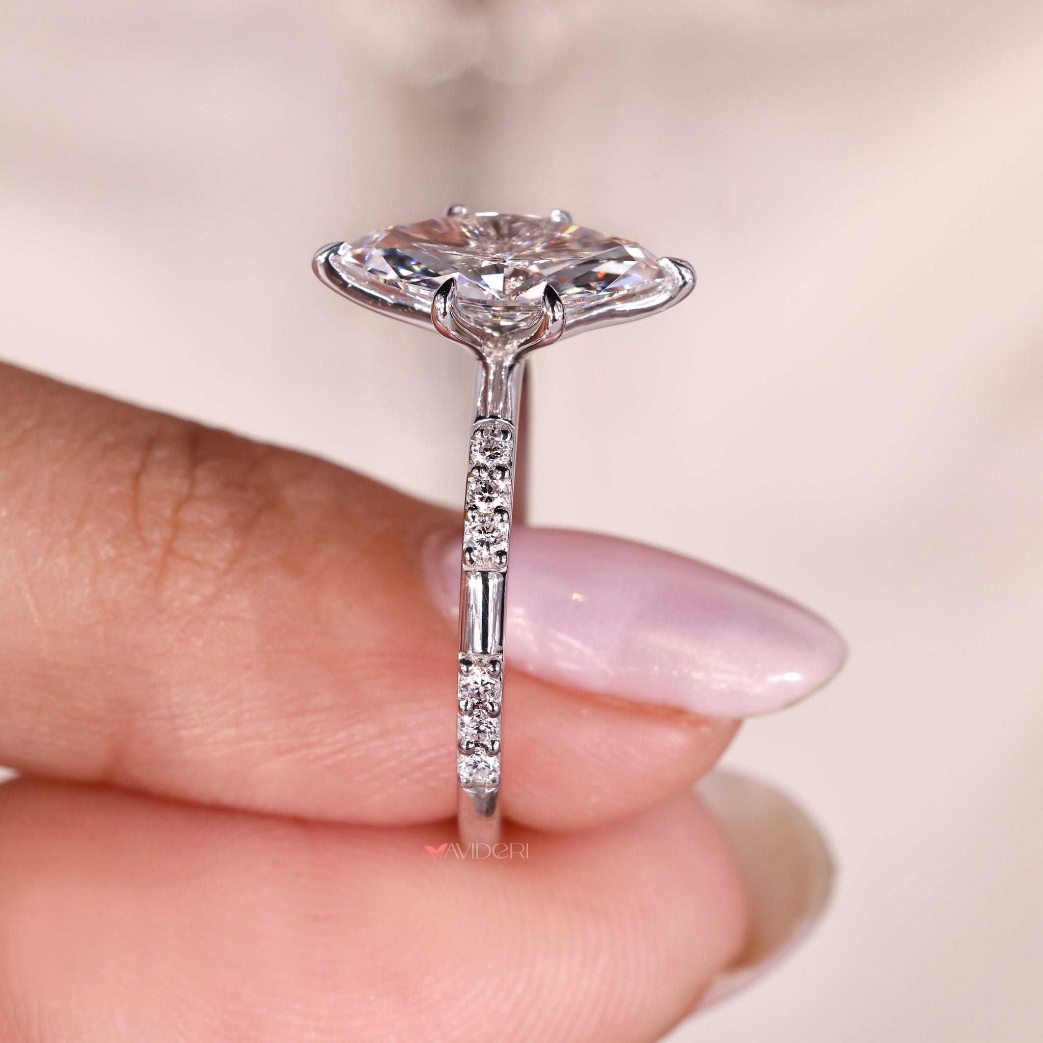 custom engagement ring with marquise diamond and lab grown round stones.