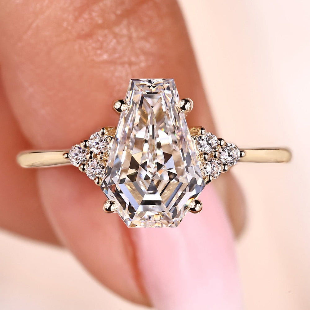 Seven stone diamond ring with coffin cut center stone.