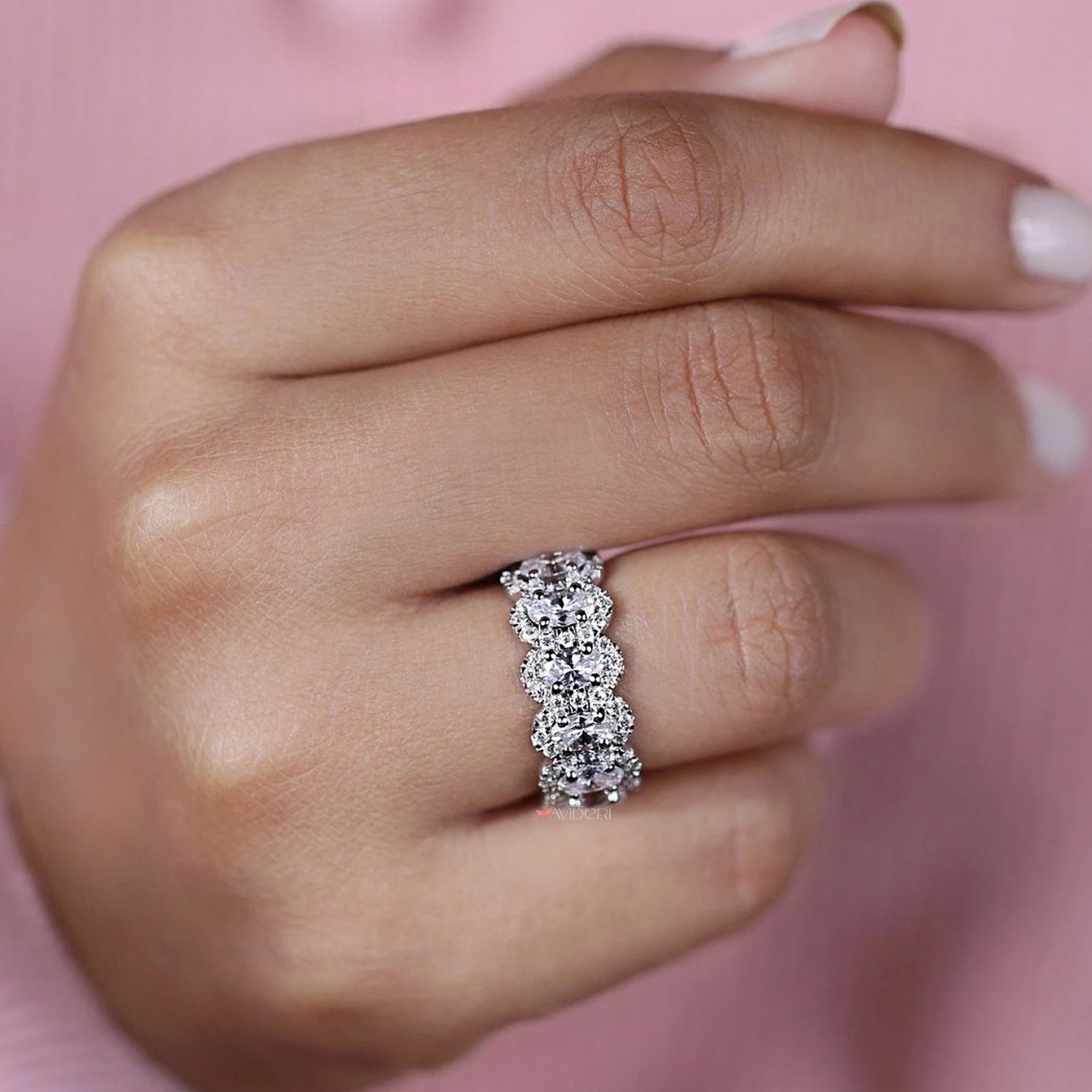 Oval cut wedding band with seven stone moissanite setting.