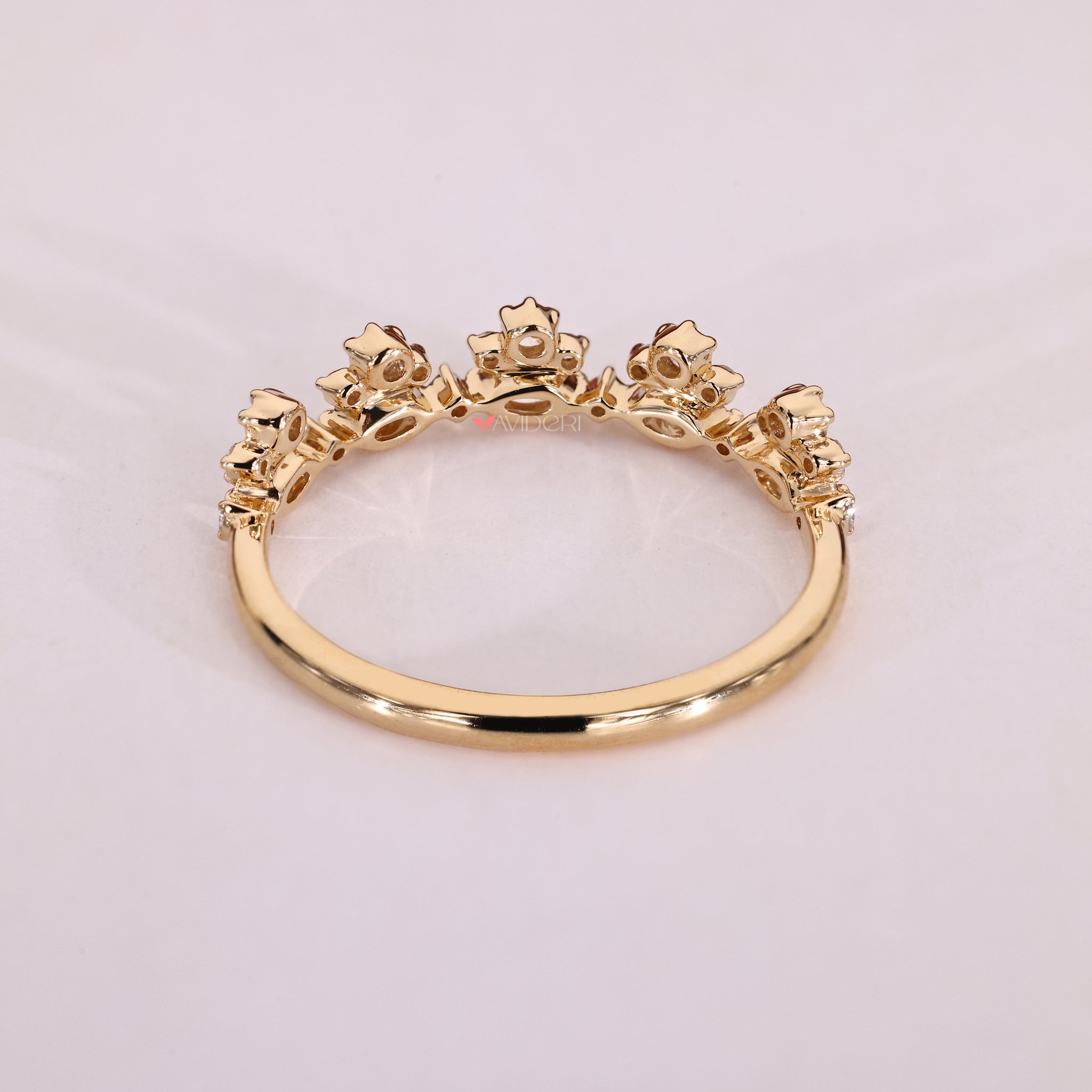 Marquise diamond cut wedding band in yellow gold with a tapered shank design.
