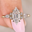 Hexagon step cut diamond ring with marquise side stones
