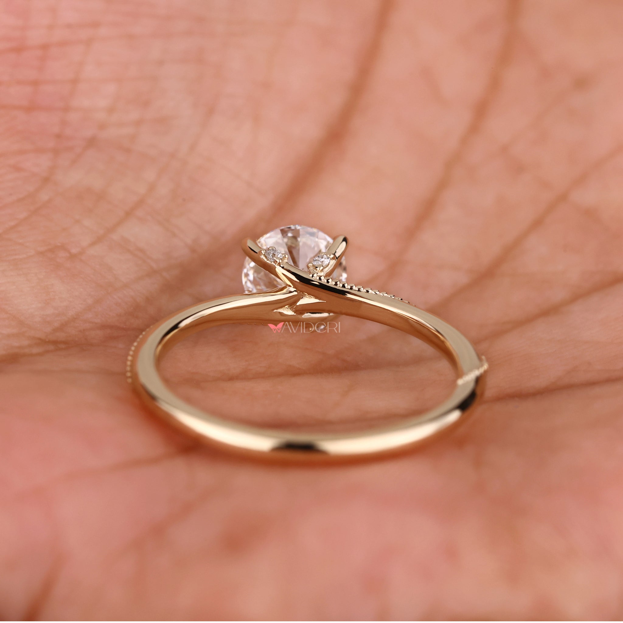 Solitaire ring with a round diamond in a stunning milgrain design, ideal for romantic proposals.
