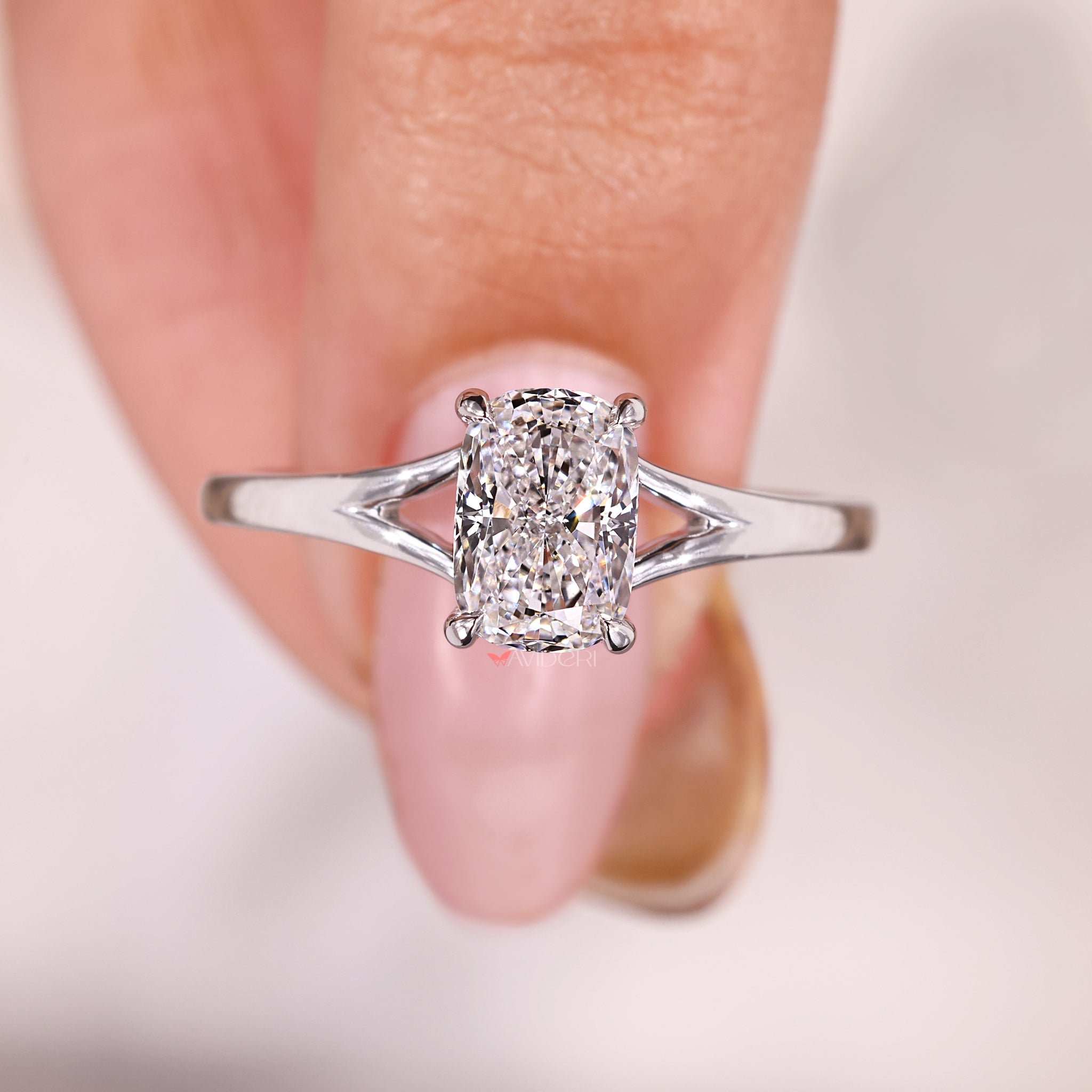Solitaire diamond ring featuring a cushion cut stone in a handmade design.