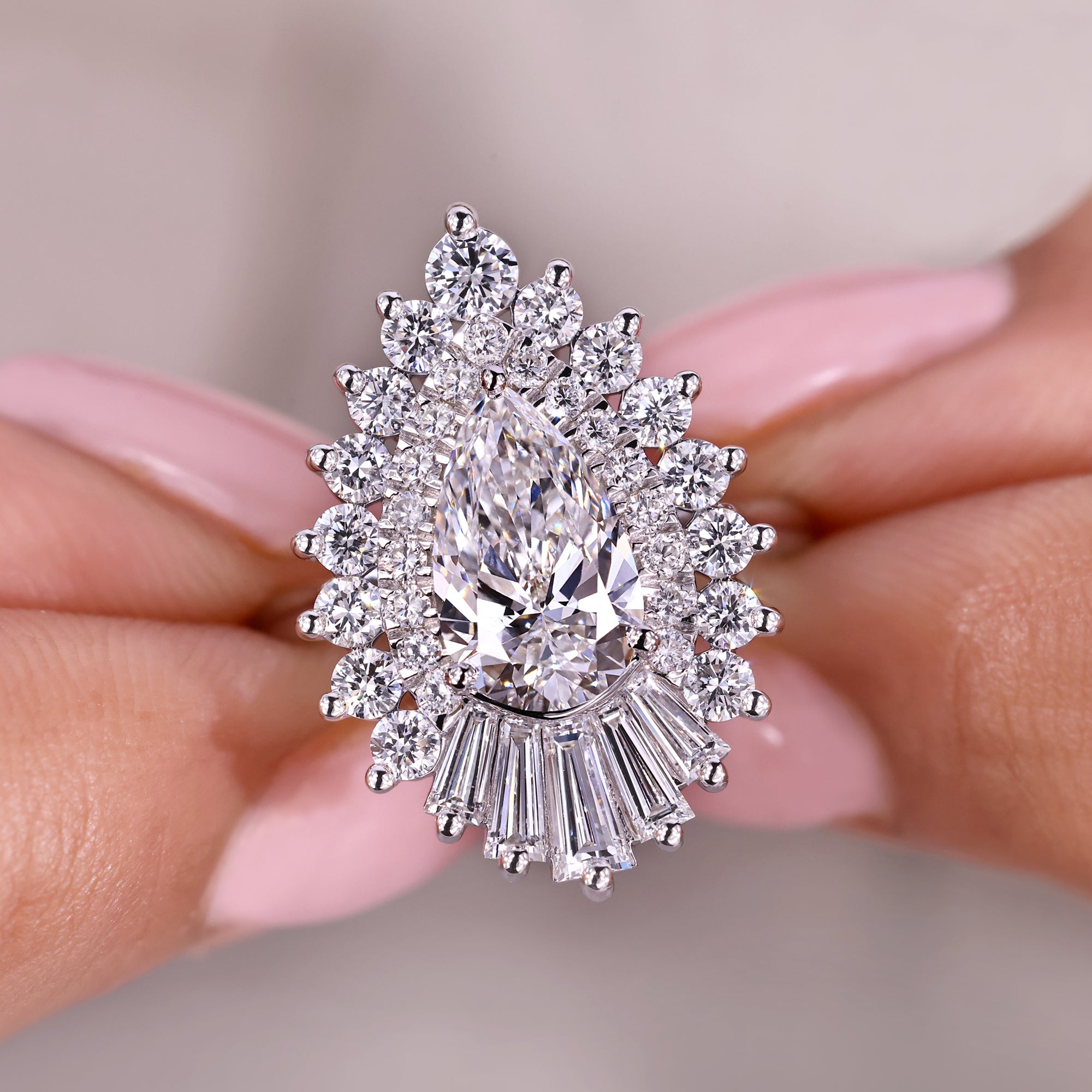 Diamond ring held between fingers with a blurred background