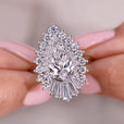 Diamond ring held between fingers with a blurred background
