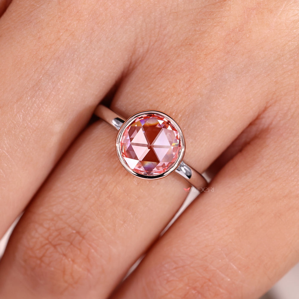 Bezel setting highlights the round rose cut diamond.