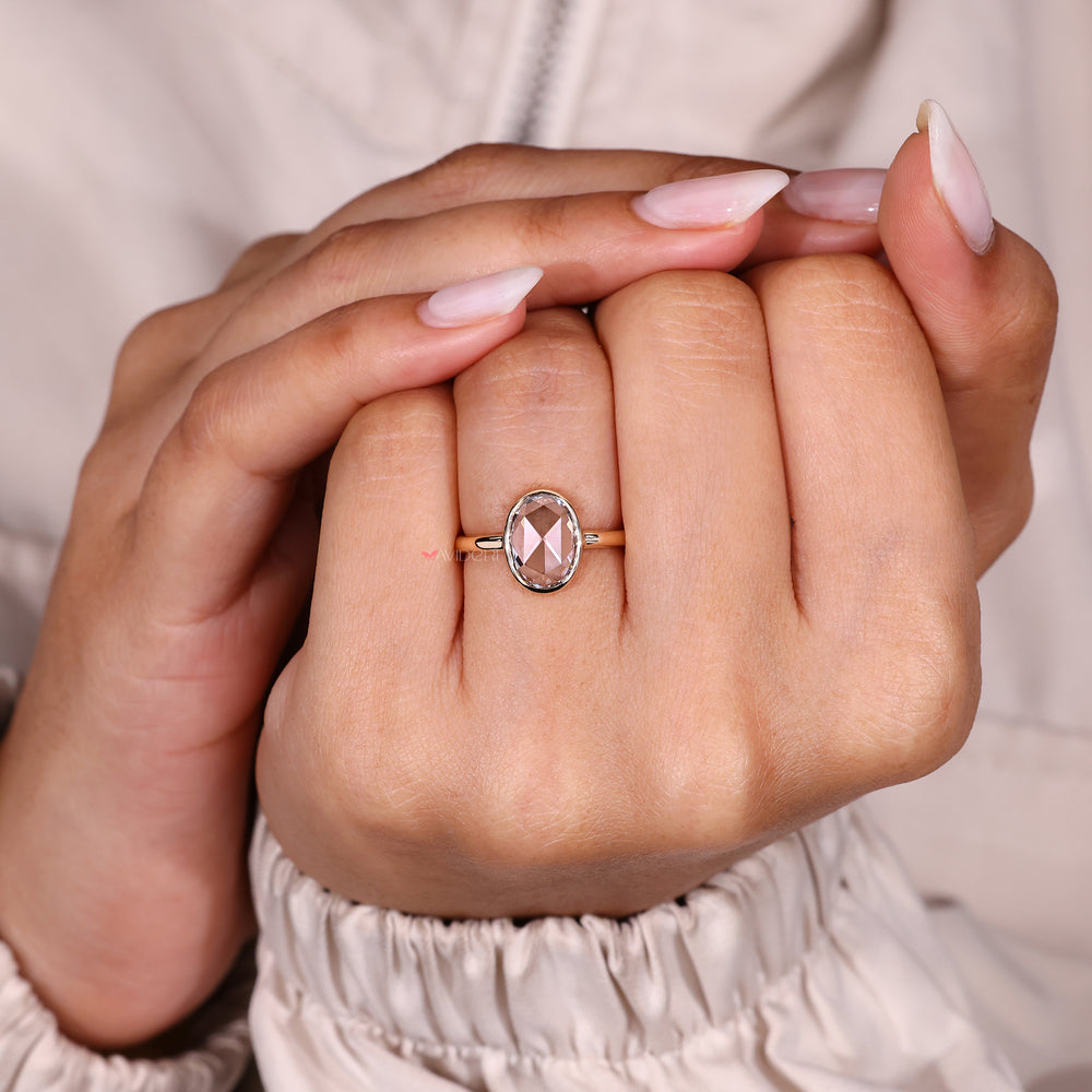 Minimal oval rose cut diamond ring with bezel.
