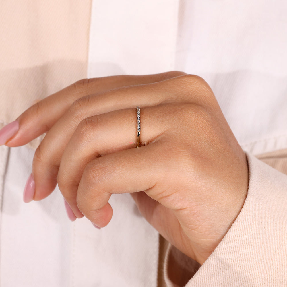 A diamond eternity band in yellow gold, designed for a classic and elegant style.
