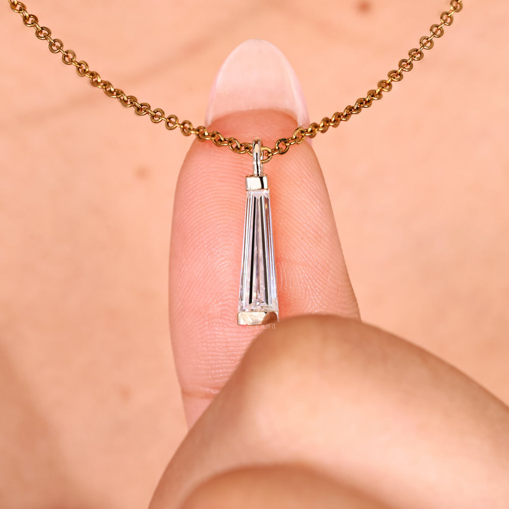 Handmade moissanite pendant with tapered baguette side accents.
