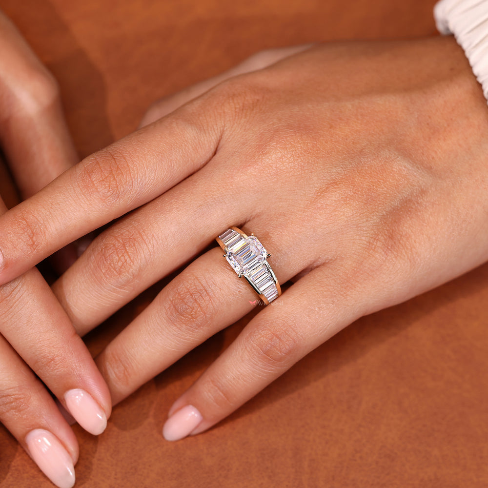 Emerald ring with tapered baguette side stones.
