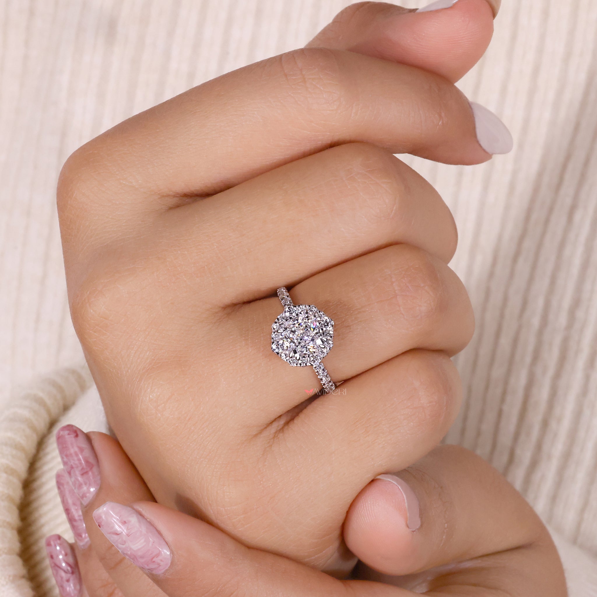 Pave diamonds in a stunning cushion halo setting, offering unmatched sparkle and charm for a memorable engagement.
