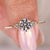 A round diamond ring with side stones, perfect as an anniversary diamond ring gift.