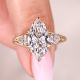 Three stone marquise diamond ring in yellow gold.