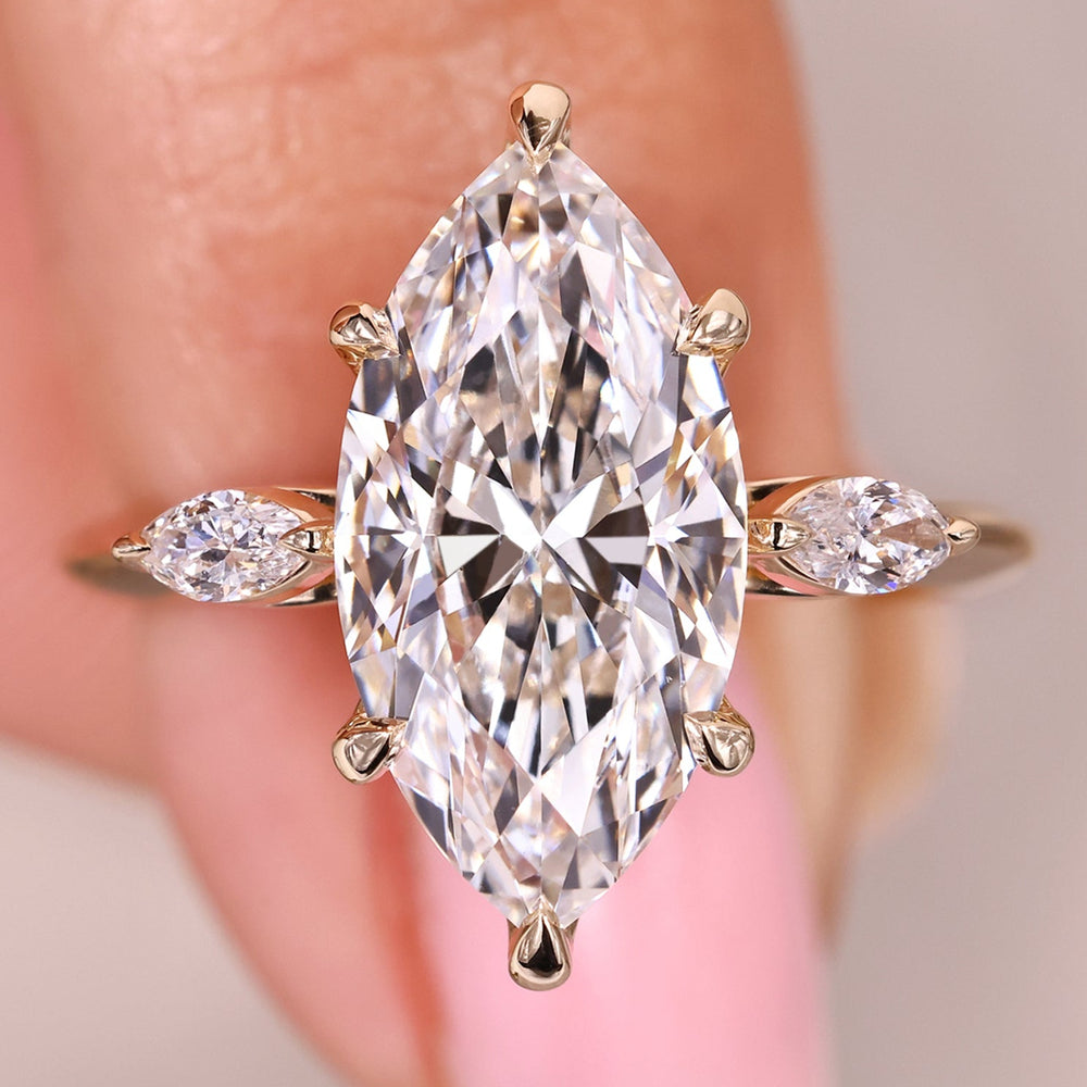 Three stone diamond ring with marquise center stone.