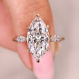 Three stone diamond ring with marquise center stone.