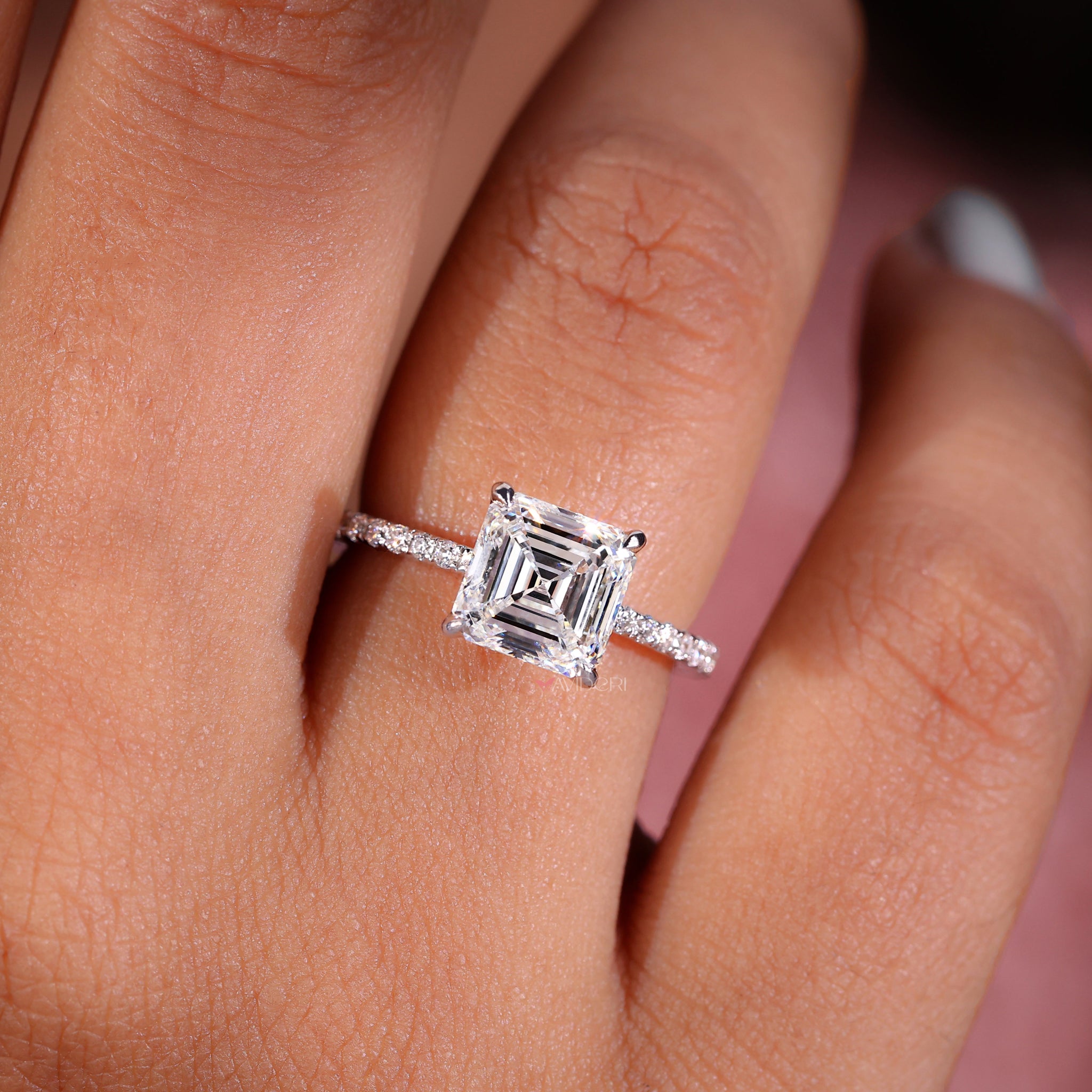 Avideri ring featuring a 4 prong round engagement ring style with an Asscher cut diamond in a pave setting.
