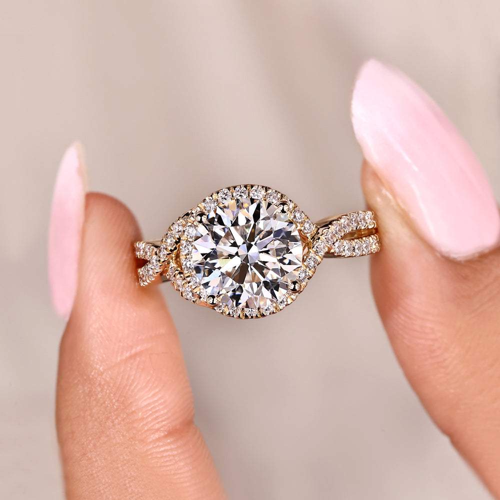 Handmade twisted shank ring with round diamond halo.
