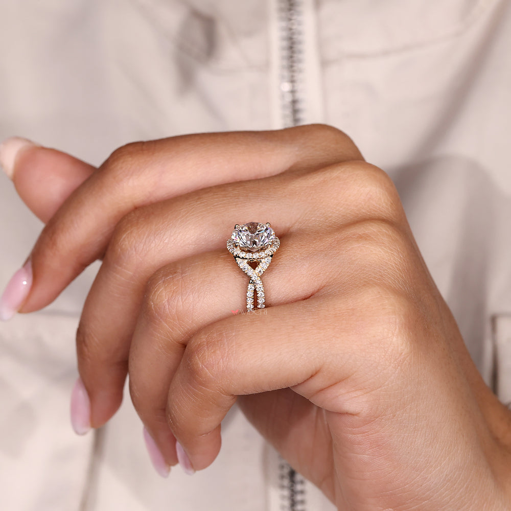 Round diamond ring with four prong twisted shank.