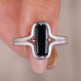 Cushion cut solitaire engagement ring with sleek white gold band
