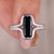 Cushion cut solitaire engagement ring with sleek white gold band
