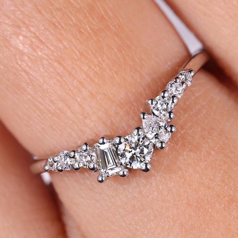 The pear and tapered baguette diamond band adds elegant sparkle.
